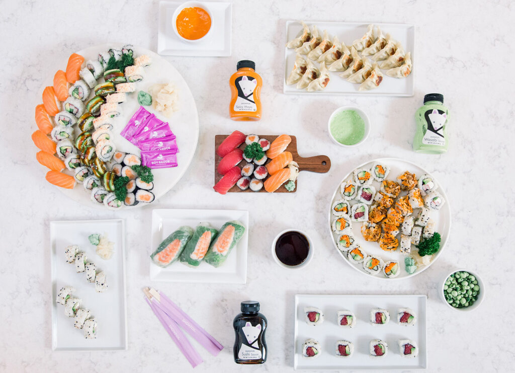 Overhead shot of different sushi plates and sauces for display